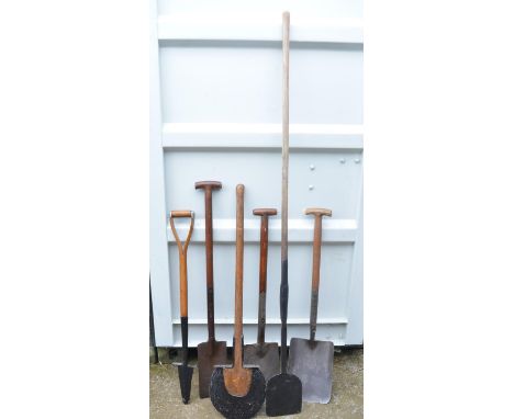 Selection of vintage wooden-handled spades and edging tools 