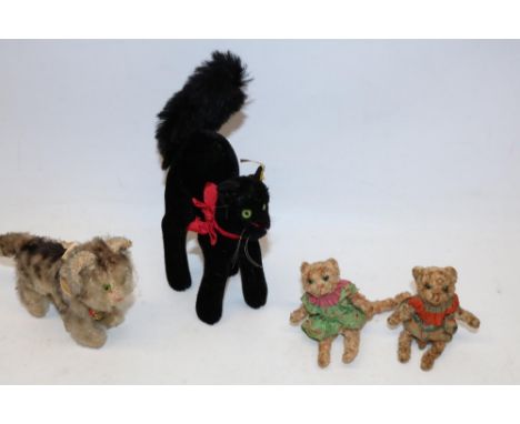 Steiff 'Tabby' cat with original paper tag, H10cm; Steiff black Halloween cat with yellow tag in ear, H20cm; and two unmarked