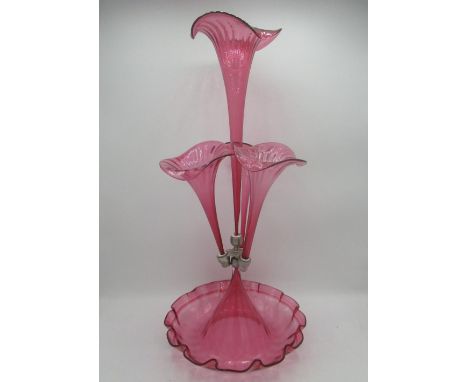 Victorian style cranberry glass epergne with four flutes on a scalloped edged circular base, H53cm 