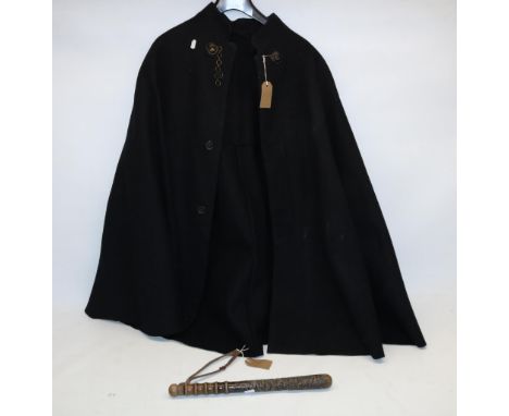 Mid 20th century woollen police cape with lion head fasteners, and a wooden truncheon with leather trap (2) 