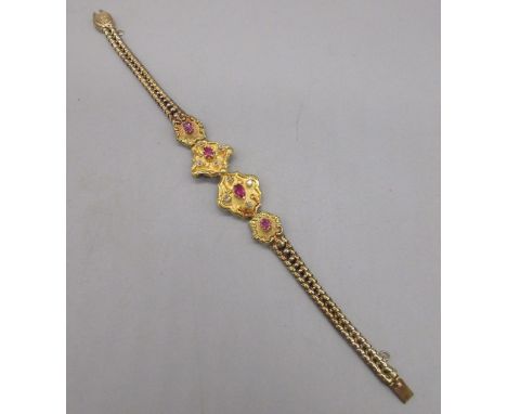 Unmarked yellow gold bracelet with ruby and diamond set panels on articulated chain, tested to 22ct with acid test, 15.2g
