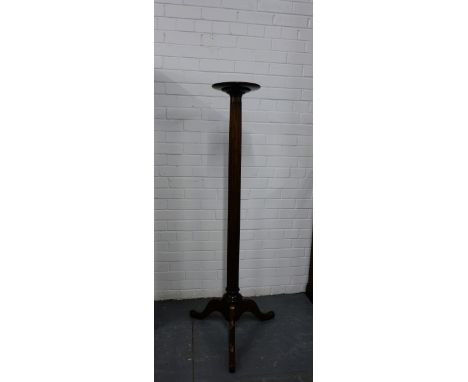 A mahogany plant stand with circular tray top on fluted column and tripod supports, 143cm