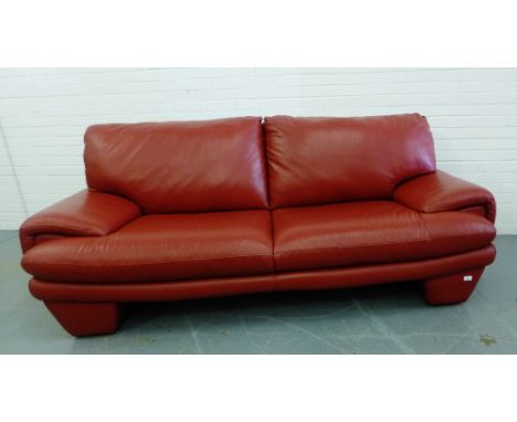 A contemporary red leather three seater sofa, 95 x 220cm