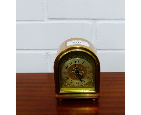 A copper and brass cased mantle clock, 11cm high 