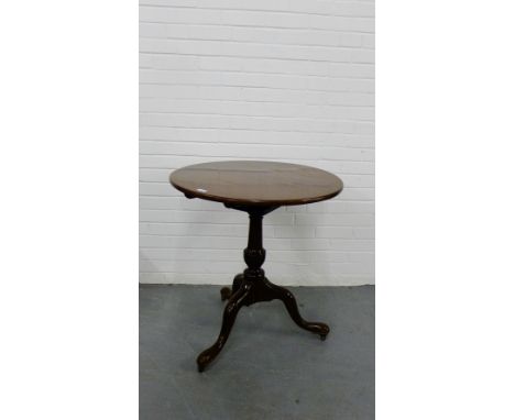 A 19th century mahogany tilt top table, the circular top on bird cage movement on column and tripod supports terminating in b