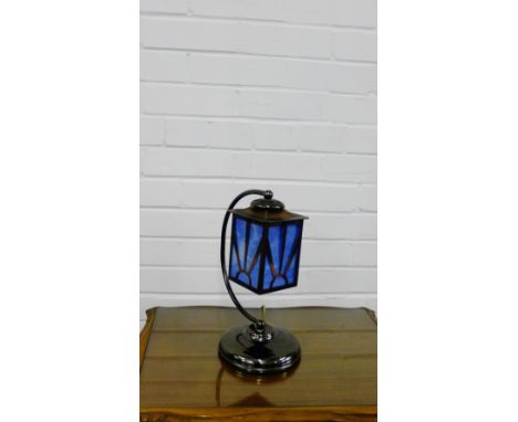 A contemporary lantern table lamp with opaque glass shade