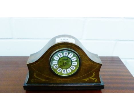 A mahogany cased and inlaid Art Nouveau style mantle clock, the brass dial with Roman numerals, raised on four bun feet, 12 x