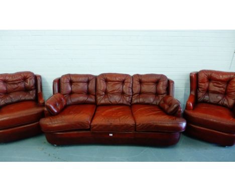 Red leather three seater sofa together with two matching wing chairs (3) 
