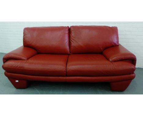 A contemporary red leather two seater sofa, 95 x 200cm