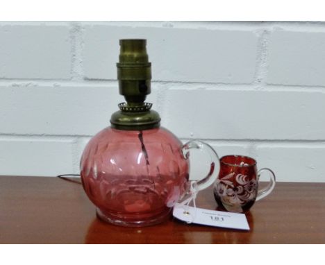 A cranberry glass jug converted to a table lamp together with a small jug (2)