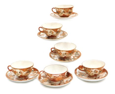A Meiji period Japanese Kutani porcelain part tea service, decorated with reserves of birds and flowers, comprising six teacu