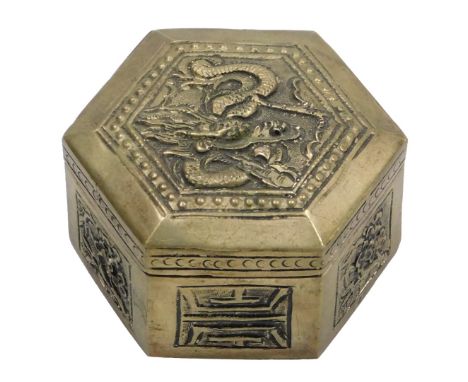 A Chinese silver plated brass box and cover, of hexagonal form the lid embossed with a dragon, the sides with flowers and lon