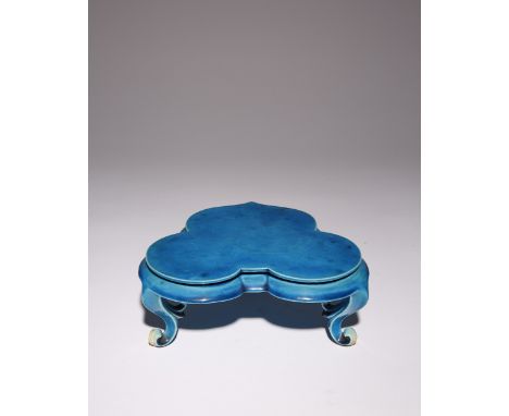 A CHINESE TURQUOISE GLAZED STAND KANGXI 1662-1722 The heart-shaped platform with a moulded edge, raised on three scroll feet,
