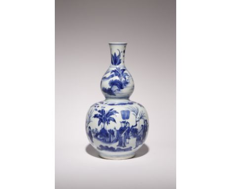 A CHINESE BLUE AND WHITE GOURD-SHAPED VASE TRANSITIONAL C.1640 The body painted with an official holding a scroll and with hi