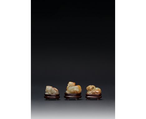 THREE SMALL CHINESE CELADON JADE CARVINGS OF ANIMALS MING DYNASTY One a recumbent ram, another a crouching qilin, the third a