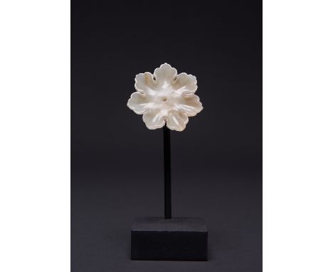A CHINESE PALE CELADON JADE FLOWER-SHAPED PLAQUE YUAN/MING DYNASTY Formed as a flower with seven petals, with a narrow, flatt
