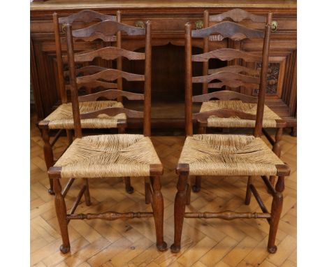 Four late 19th / early 20th Century rush-seated oak ladder-back chairs, 95 cm