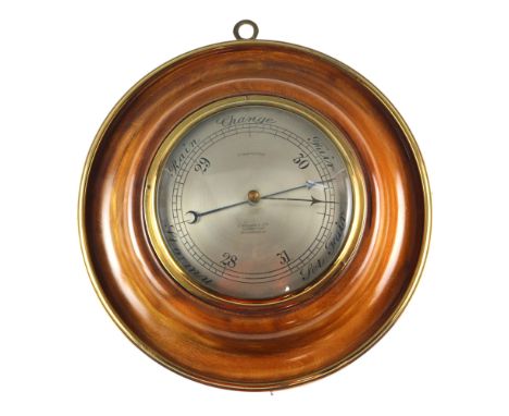 Am aneroid wall barometer by A Franks Ltd, opticians, Manchester, having a convex silvered dial and conforming glass with bra