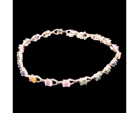 A contemporary gem-set 9 K yellow metal bracelet, comprising variously coloured oval-cut stones, claw-set on open arrow-shape