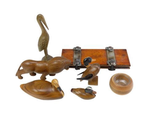 A small quantity of wooden animal figurines including a family of ducks made by the Wichi of Argentina, a stork, a lion, etc,
