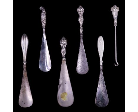 Five antique silver-handled shoe horns together with a white-metal glove button hook