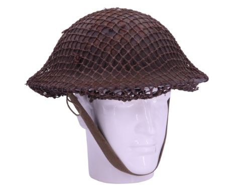 A Second World War British army Mk 2 steel helmet with camouflage net