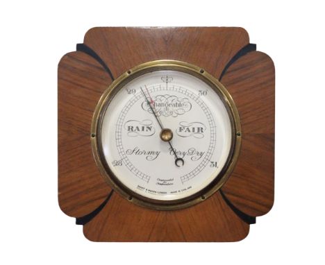 An Art Deco aneroid barometer by Short &amp; Mason of London, in an ebonised and walnut case, 21.5 x 21.5 cm, (functioning wh