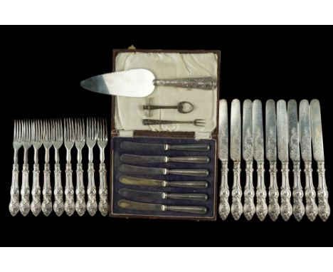 A Victorian set of nine silver-handled fruit forks with knives, together with a cased set of silver handled tea knives, a sil