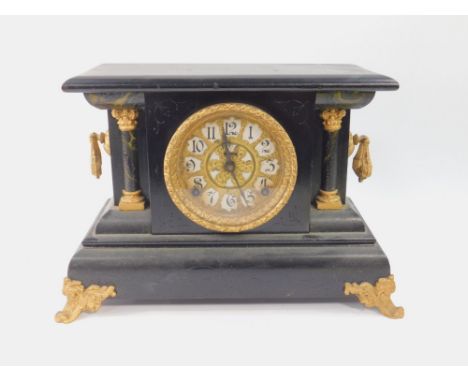 An American ebonised and gilt metal mantel clock, late 19thC, circular brass dial bearing Arabic Numerals, eight day movement