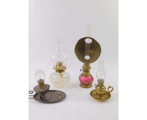 A Kosmos wall mounted gimbal wall mounted lamp, a brass oil lamp chamber stick, and a pressed glass oil lamp with a glass sha