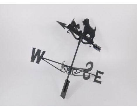 A wrought and cast iron weather vane, surmounted with two Scottie Dogs, 71cm high.