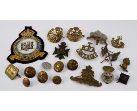 A group of Army and RAF cap badges and buttons, including The Cheshire Regiment, Royal Artillery and Lincolnshire Regiments. 