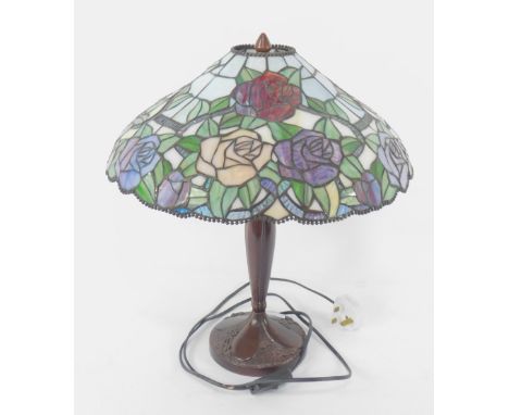 A Tiffany style table lamp with a glass shade decorated with roses, 48cm high.