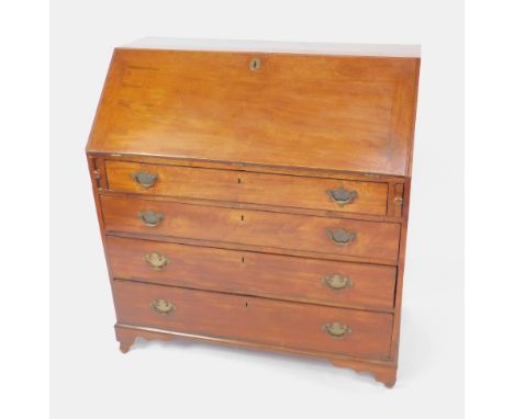 A George III mahogany bureau, the fall flap opening to reveal a central door flanked by drawers and recesses, over four long 