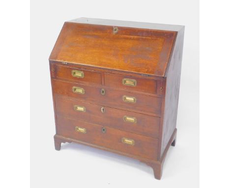 A George III oak chest of drawers, the fall flap opening to reveal a separate door flanked by drawers and recesses, over two 