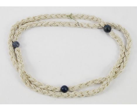 A string of plaited seed pearl beads, set with Lapis Lazuli beads at intervals, 109cm long.