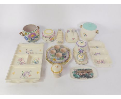 A group of Poole pottery traditionally decorated with flowers, including biscuit barrels, preserve pots, five division toast 