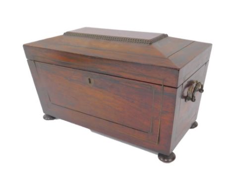 A Regency rosewood sarcophagus tea caddy, with a pair of carrying handles, brass strung, the lid opening to reveal two compar