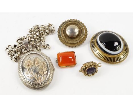A Victorian banded agate and niello oval photo locket mourning brooch, set with a banded cabochon agate, reverse bearing port