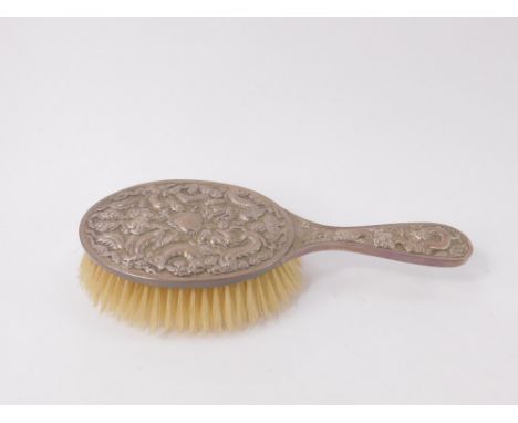 A Chinese late 19th C hairbrush, silver backed white metal, embossed with dragons, amongst clouds, and a serpent amongst flow