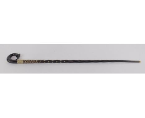 An Indian ebony and ivory inlaid late 19thC walking stick, the handle formed as the head of a bird, with a plated shield embo