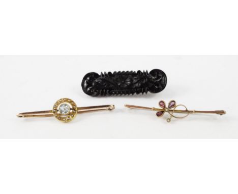 An Edwardian amethyst and seed pearl floral bar brooch, set in yellow metal, stamped 9ct, an aquamarine and seed pearl wheel 