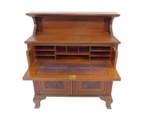 A Victorian mahogany secretaire cupboard, the shelf back above a drawer, opening to reveal recesses, above a pair of carved p