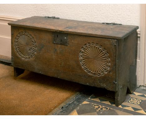 A 17th century carved oak six plank coffer, with later blacksmith made shaped iron hinges, 93 cm wide, removal cost AReport b