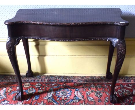 An 18th century style Chippendale serpentine front table, on carved cabriole legs with claw and ball feet, 93 cm wide, remova