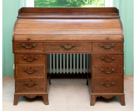 A 19th century inlaid mahogany cylinder desk, the three quarter gallery above a tambour section with slide out desk, above an