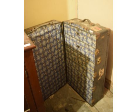 An early 20th century travelling trunk, with drawers and a hanging section, 106 cm wide, removal cost B 