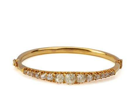 AN OLD MINE CUT DIAMOND HINGED BANGLE The hinged bangle set with a row of graduated old mine cut diamonds   Accompanied by Na