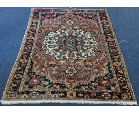 A good tapestry rug decorated in bright colours. Approx. 150 cms x 200 cms. Est. £40 - £60.