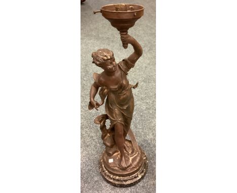 A tall spelter lamp depicting a lady on marble base. Est. £30 - £40.